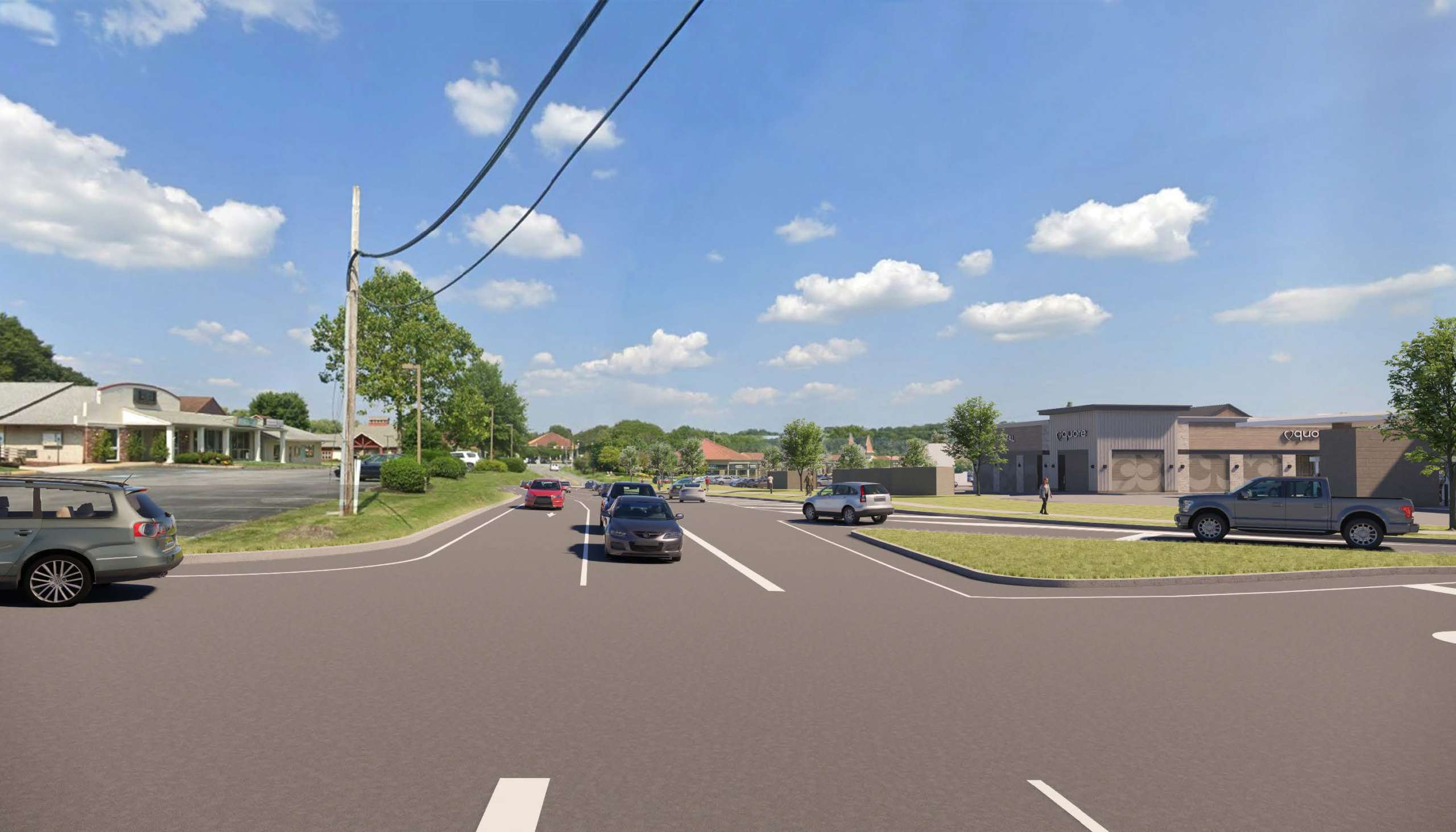 Wide suburban street intersection with parked cars, a strip mall on the right, and a blue, cloudy sky above.