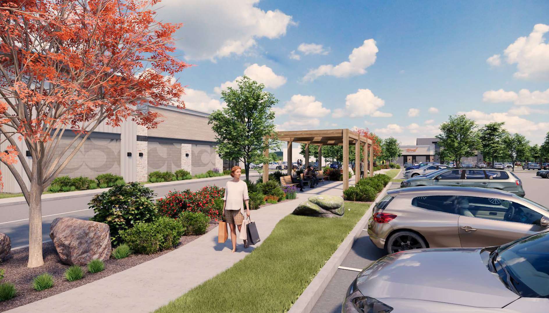 Sidewalk along a shopping plaza with a wooden pergola seating area, greenery, and a row of parked cars under a blue sky.