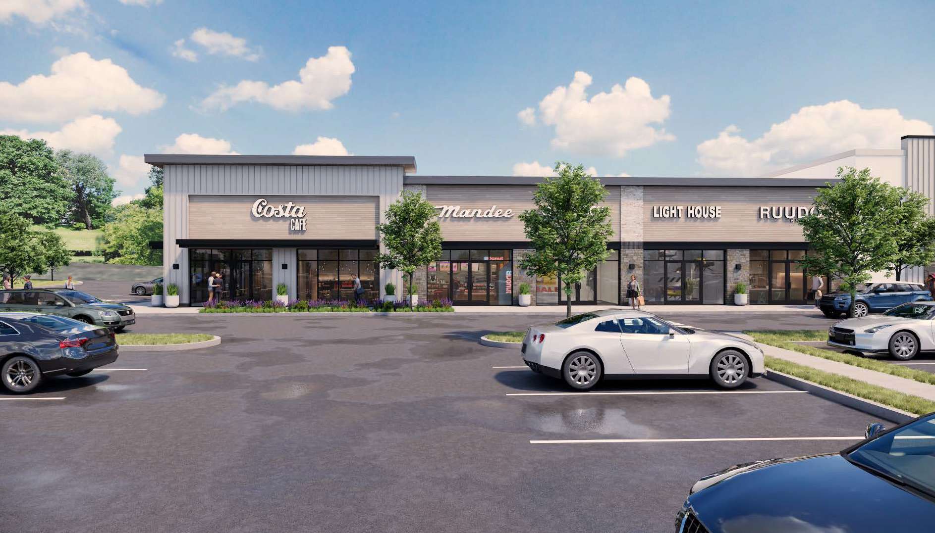 Wide view of a modern shopping strip with Costa Cafe and other storefronts, trees, and a parking lot under a blue sky