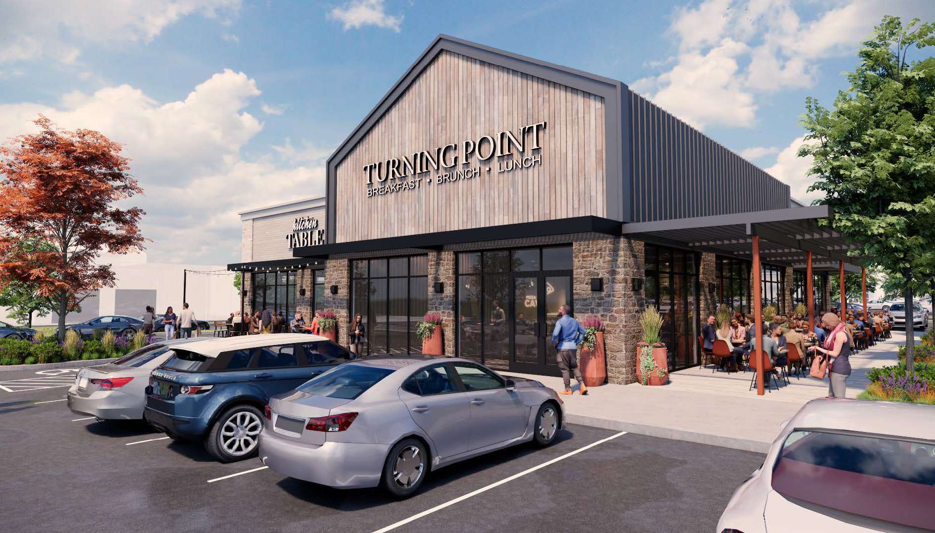 Exterior view of Turning Point restaurant with outdoor dining, parked cars, and landscaped entry. (Brunch spot with patio seating)